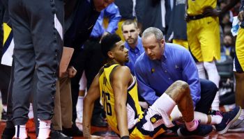 Pacers guard Jeremy Lamb sits on the ground after injuring his left knee during the 2019-20 season.