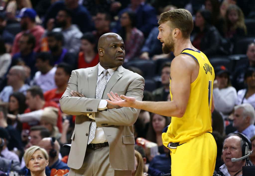 Pacers head coach Nate McMillan and forward Domantas Sabonis talk during a 2020 road loss.