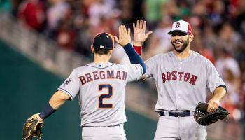 Mitch Moreland of the Boston Red Sox high fives Alex Bregman of the Houston Astros after the 89th MLB All-Star Game.