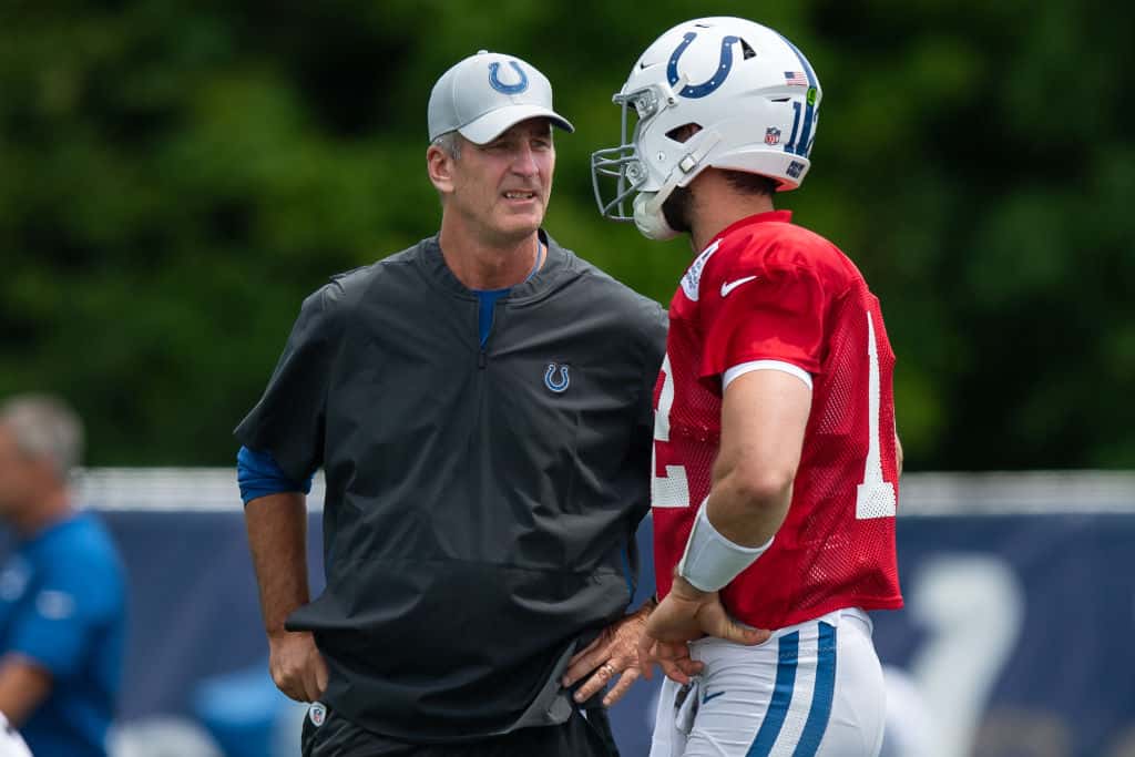 Colts head coach Frank Reich talks with quarterback Andrew Luck during a 2019 camp practice at Grand Park.