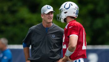 Colts head coach Frank Reich talks with quarterback Andrew Luck during a 2019 camp practice at Grand Park.