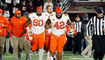Clemson defensive linemen Dexter Lawrence and Christian Wilkins run out of the tunnel before a 2018 game.