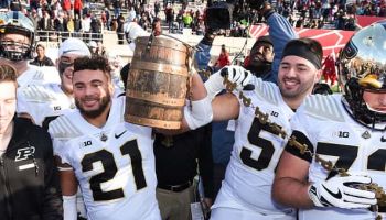 Members of the Purdue football team celebrates with the Old Oaken Bucket after beating IU in Bloomington on November 24