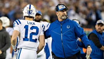 Colts head coach Frank Reich high fives Andrew Luck during a Week 17 game against the Titans in 2018.