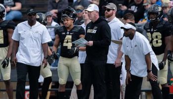 Purdue Boilermakers head coach Jeff Brohm and Purdue Boilermakers wide receiver Rondale Moore (4) on the sidelines