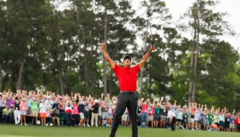 Tiger Woods celebrates at the final hole after winning the Master's championship