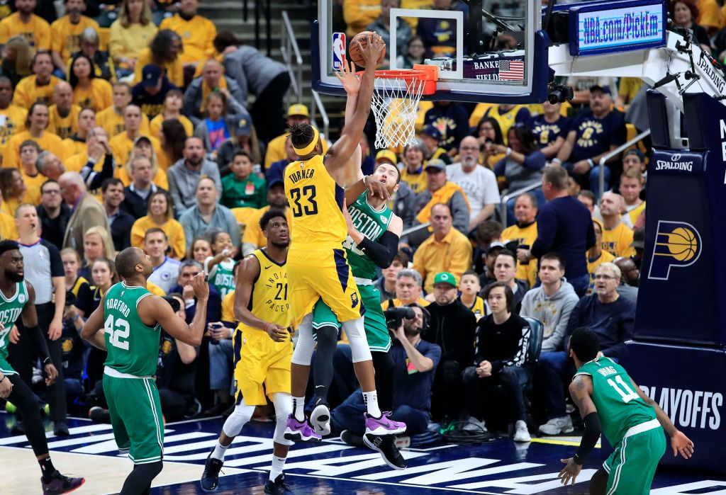 Myles Turner (#33) of the Indiana Pacers dunks the ball over Aaron Baynes of the Boston Celtics