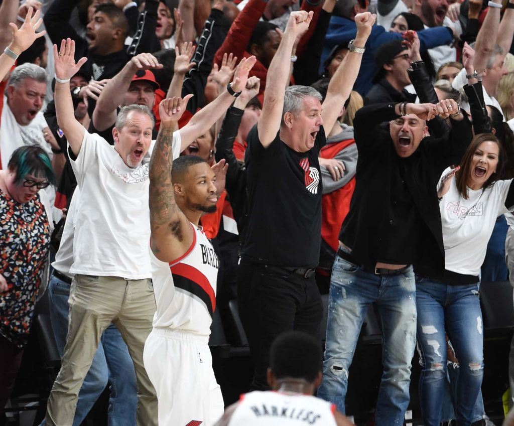Damian Lillard reacts after hitting a 37-foot game winner against the Thunder. Portland fans cheer crazily in the background