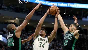 Giannis Antetokounmpo, #34 for the Bucks, goes up for a shot against Al Horfoed and Jayson Tatum of the Celtics