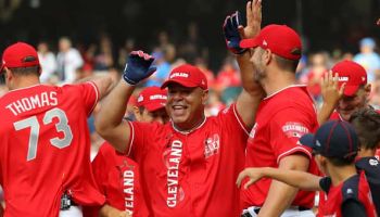 Former MLB All-Star Carlos Baerga celebrates with his teammates after hitting a home run during the Legends & Celebrity Softball