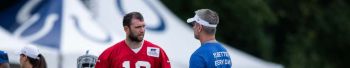 Colts quarterback Andrew Luck talks with head coach Frank Reich before a 2019 practice at Grand Park.