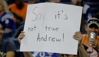 An Indianapolis Colts fan holds up a sign after Adam Schefter tweeted that Andrew Luck was planning on retiring
