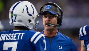 Colts quarterback Jacoby Brissett listens to head coach Frank Reich during a 2019 game.