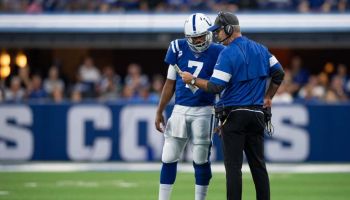 Colts quarterback Jacoby Brissett talks with Frank Reich during a 2019 game.