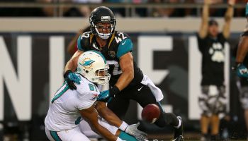 Dustin Keller #81 of the Miami Dolphins catches a touchdown pass over Chris Prosinski #42 of the Jacksonville Jaguars during a p