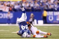 Jack Doyle #84 of the Indianapolis Colts is tackled by Rey Maualaga #58 of the Cincinnati Bengals