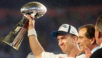 Quarterback Peyton Manning #18 of the Indianapolis Colts celebrates with the Vince Lombardi Super Bowl trophy