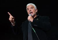 Actor John O'Hurley performing on stage.