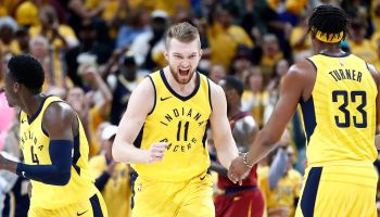 Domantas Sabonis celebrates with Victor Oladipo and Myles Turner looking on