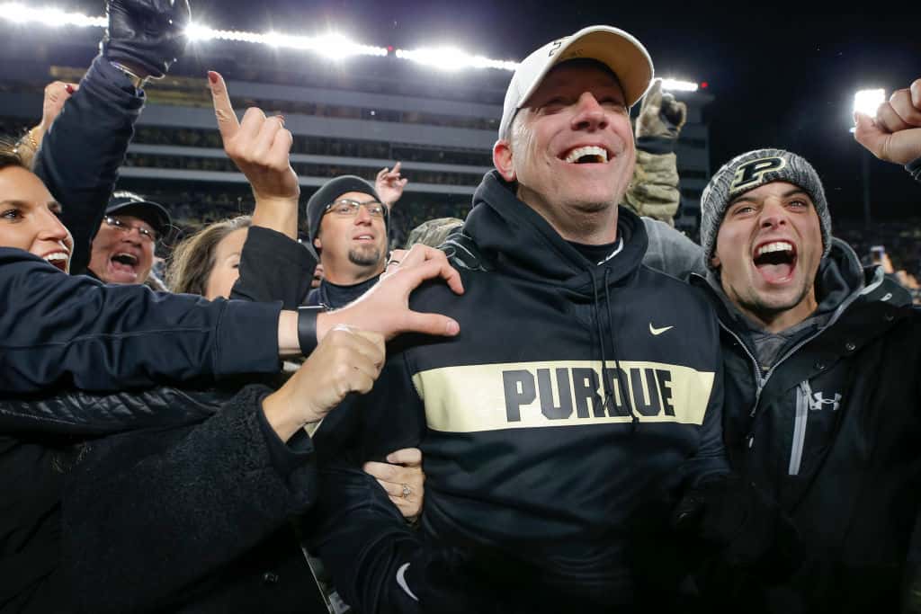 Jeff Brohm and the crowd storm the field