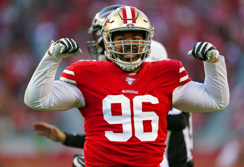 Former 49ers defensive lineman Sheldon Day flexes after making a play.