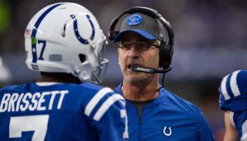 Colts head coach Frank Reich talks to Jacoby Brissett in a game.