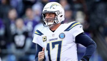 Former Chargers quarterback Philip Rivers runs out of the tunnel.