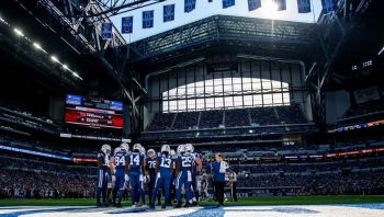 The Colts gather in the huddle before a play at Lucas Oil Stadium.