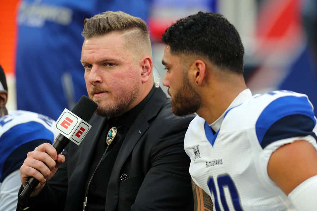 Pat McAfee interviewing quarterback Jordan Ta'amu on bench