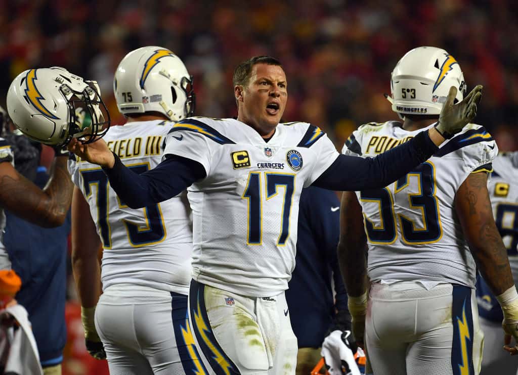 Quarterback Philip Rivers #17 of the Los Angeles Chargers protests a non-call after being hit in the helmet during the game against the Kansas City Chiefs at Arrowhead Stadium