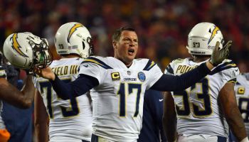 Quarterback Philip Rivers #17 of the Los Angeles Chargers protests a non-call after being hit in the helmet during the game against the Kansas City Chiefs at Arrowhead Stadium