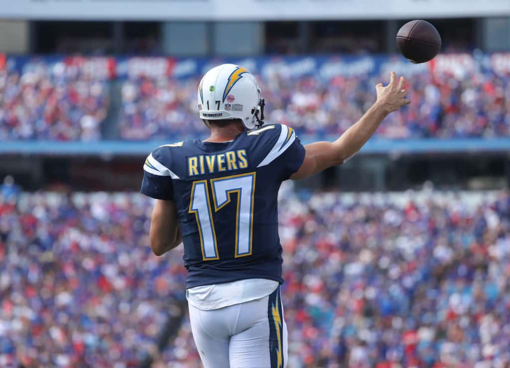 Philip Rivers #17 of the Los Angeles Chargers warms up near the sideline during NFL game action against the Buffalo Bills