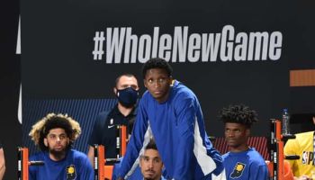 Pacers guard Victor Oladipo watches from the bench in the Pacers re-start.