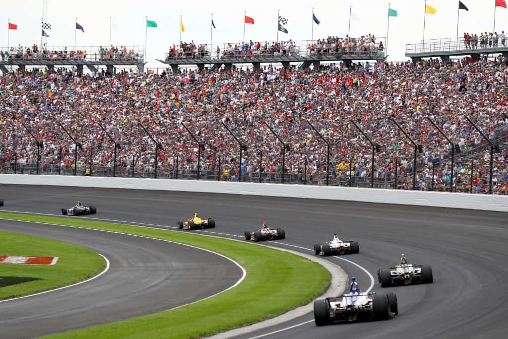 The field takes the turn one after the restart during the 103rd Indianapolis 500 at Indianapolis Motor Speedway on May 26, 2019 in Indianapolis, Indiana