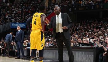 Pacers coach Nate McMillan talks to Victor Oladipo during a game.