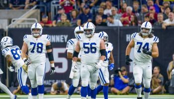 Colts offensive linemen walk up to the line of scrimmage.