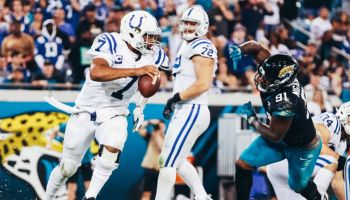 Jacoby Brissett evades a Jacksonville defender and looks down field as the Colts face the Jaguars