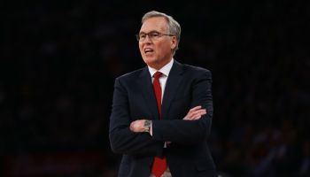 Former Houston Rockets coach Mike D'Antoni looks to the court from the sideline coaching in a game with his arms crossed