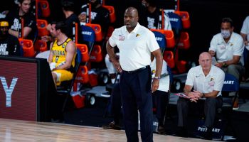 Former Pacers head coach Nate McMillan stands on the floor while now former assistant Dan Burke sits and watches as the Pacers play in the Orlando bubble
