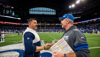 Head coaches Mike Vrabel and Frank Reich shake hands after a game.