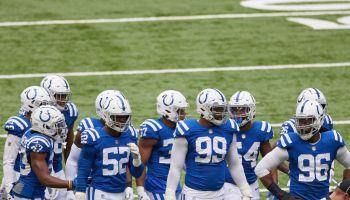 Numerous members of the Colts defensive core huddle at Lucas Oil Stadium