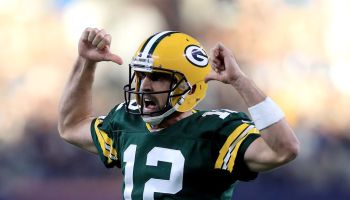 Packers QB-Aaron Rodgers points to his jersey.