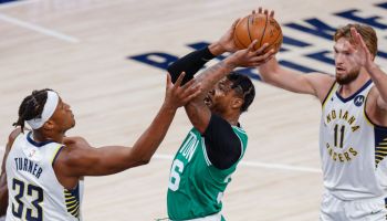 Myles Turner and Domantas Sabonis defend Boston Celtics guard Marcus Smart at Bankers Life Fieldhouse