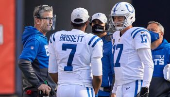 Colts quarterbacks chat with Frank Reich during a game.