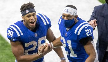 Colts running backs Nyheim Hines and Jonathan Taylor celebrate after a play.