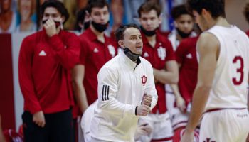 Archie Miller shouts instructions from the Indiana sideline with his bench players behind him