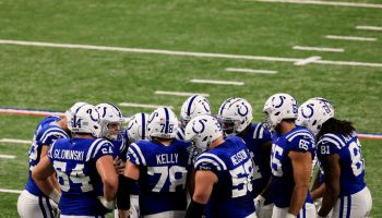 Colts offense gathers for a huddle.