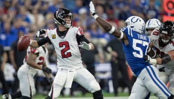 Matt Ryan looks downfield to try and pass the football with Colts Lineman Kemoko Turay coming in to swat it away