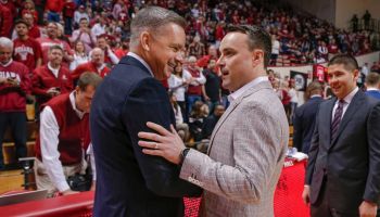 Chris Holtmann and Archie Miller shake hands in front of the scorer's bench before a game between Ohio State and Indiana at Assembly Hall