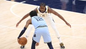 Pacers forward Justin Holiday stretches out his arms to guard Grizzlies star Ja Morant